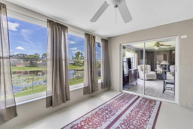 7701 Anaheim Ave, New Port Richey, FL 34655 - doorway to outside with ceiling fan and a water view