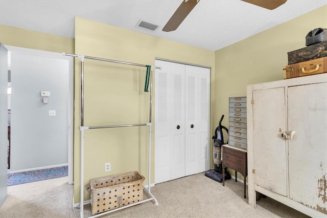 7701 Anaheim Ave, New Port Richey, FL 34655 - bedroom featuring carpet, a closet, a ceiling fan, and a textured ceiling