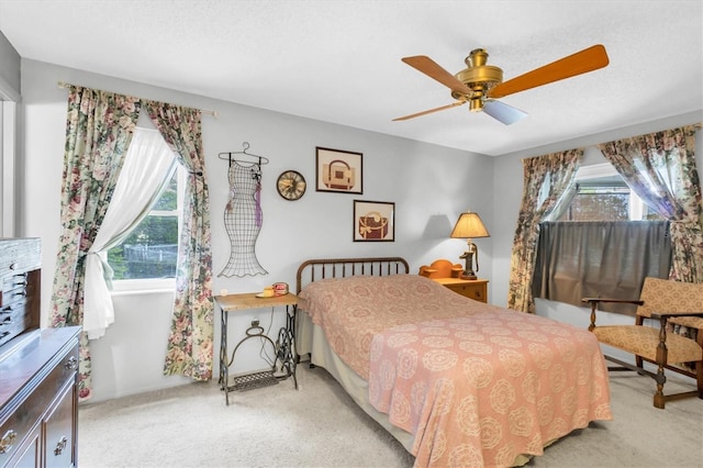 7701 Anaheim Ave, New Port Richey, FL 34655 - bedroom with light colored carpet, multiple windows, and ceiling fan
