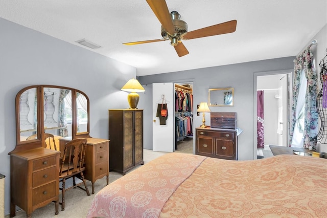 7701 Anaheim Ave, New Port Richey, FL 34655 - carpeted bedroom with a walk in closet, a closet, a desk, ensuite bathroom, and a ceiling fan
