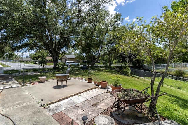 7701 Anaheim Ave, New Port Richey, FL 34655 - fenced backyard with a patio area and an outdoor fire pit