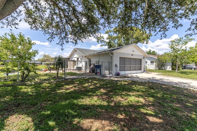 7701 Anaheim Ave, New Port Richey, FL 34655 - view of front of house with driveway, an attached garage, a gate, and brick siding