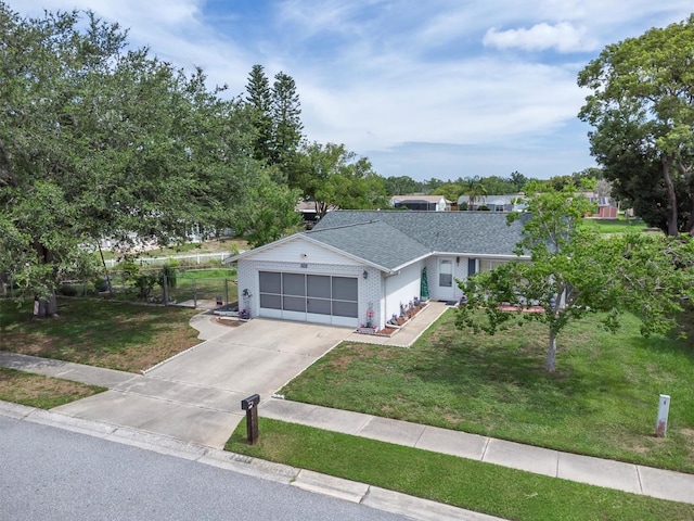 7701 Anaheim Ave, New Port Richey, FL 34655 - ranch-style house with driveway, a garage, and a shingled roof