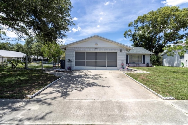 7701 Anaheim Ave, New Port Richey, FL 34655 - ranch-style house with brick siding, driveway, and a garage