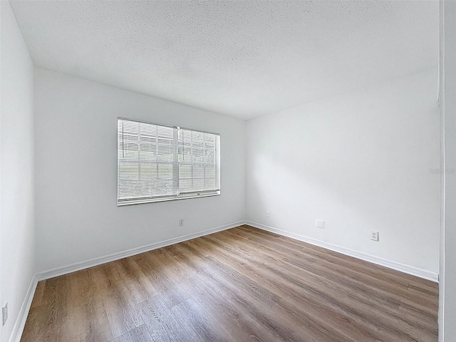 3712 Trophy Blvd Unit 3712, New Port Richey, FL 34655 - empty room featuring wood finished floors and a textured ceiling