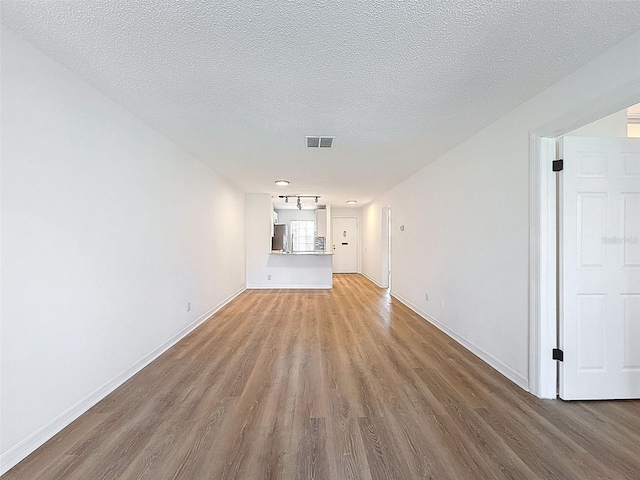 3712 Trophy Blvd Unit 3712, New Port Richey, FL 34655 - unfurnished living room with light wood-style floors and a textured ceiling