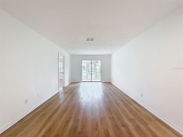 3712 Trophy Blvd Unit 3712, New Port Richey, FL 34655 - empty room with wood finished floors and a textured ceiling