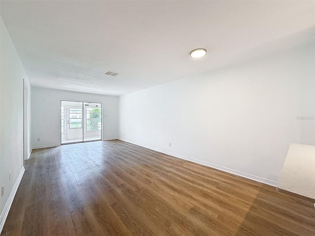 3712 Trophy Blvd Unit 3712, New Port Richey, FL 34655 - spare room featuring wood finished floors and a textured ceiling