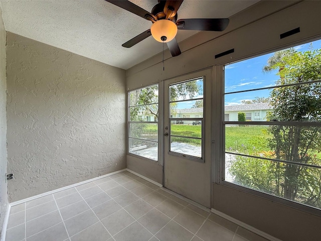 3712 Trophy Blvd Unit 3712, New Port Richey, FL 34655 - unfurnished sunroom featuring a textured wall, vaulted ceiling, tile patterned flooring, and a textured ceiling