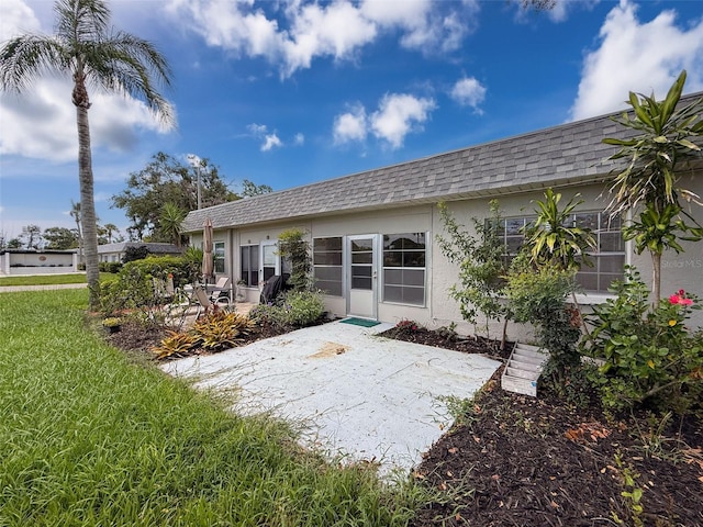3712 Trophy Blvd Unit 3712, New Port Richey, FL 34655 - rear view of house with a patio area, roof with shingles, mansard roof, stucco siding, and a yard