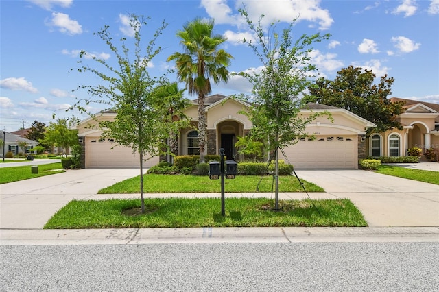 20820 Amanda Oak Ct, Land O Lakes, FL 34638 - view of front facade featuring a garage, driveway, stucco siding, and a front yard