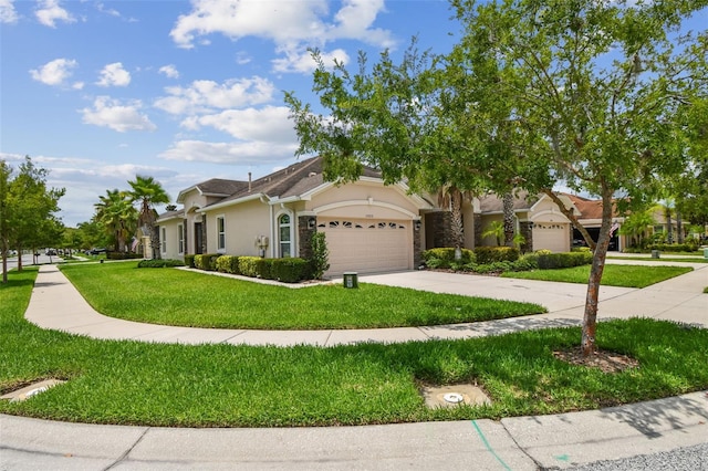 20820 Amanda Oak Ct, Land O Lakes, FL 34638 - view of front of property with stucco siding, a garage, concrete driveway, a front lawn, and stone siding