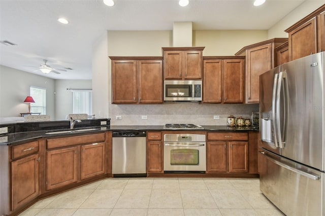 20820 Amanda Oak Ct, Land O Lakes, FL 34638 - kitchen with stainless steel appliances, backsplash, brown cabinets, and recessed lighting