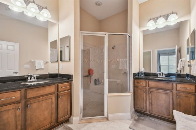 20820 Amanda Oak Ct, Land O Lakes, FL 34638 - bathroom with a stall shower, two vanities, tile patterned floors, and lofted ceiling