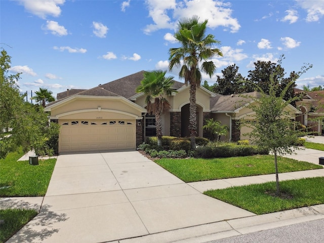 20820 Amanda Oak Ct, Land O Lakes, FL 34638 - view of front of home with stucco siding, an attached garage, concrete driveway, and a front yard