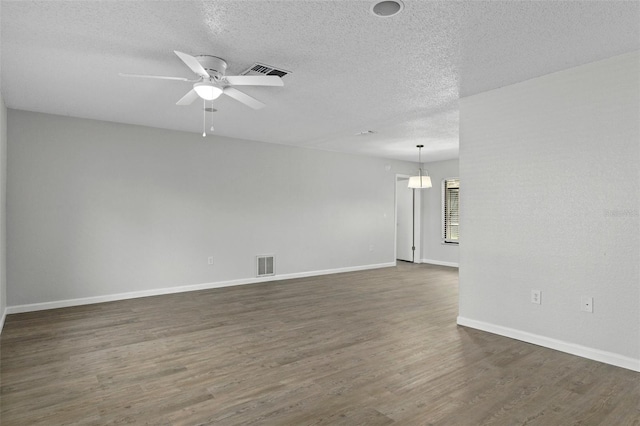 2152 Danforth Rd, Spring Hill, FL 34608 - spare room with a textured ceiling, dark wood-style floors, and a ceiling fan
