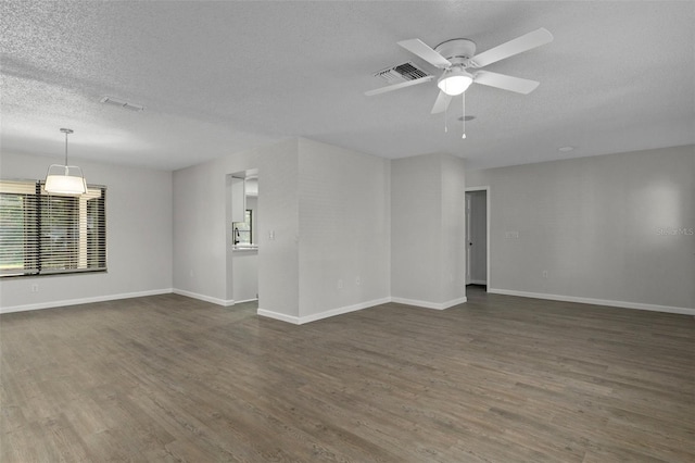 2152 Danforth Rd, Spring Hill, FL 34608 - unfurnished room with a textured ceiling, dark wood finished floors, and ceiling fan