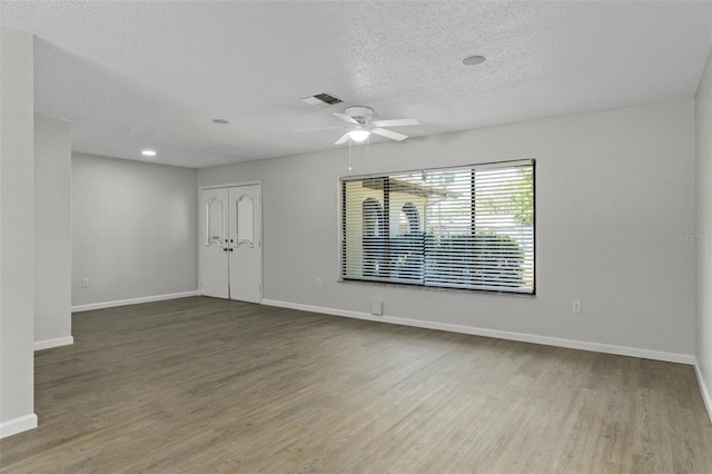2152 Danforth Rd, Spring Hill, FL 34608 - spare room with wood finished floors, ceiling fan, and a textured ceiling