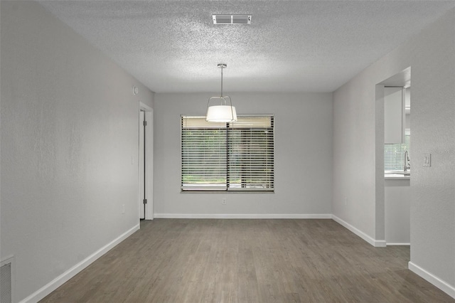 2152 Danforth Rd, Spring Hill, FL 34608 - unfurnished room featuring wood finished floors and a textured ceiling
