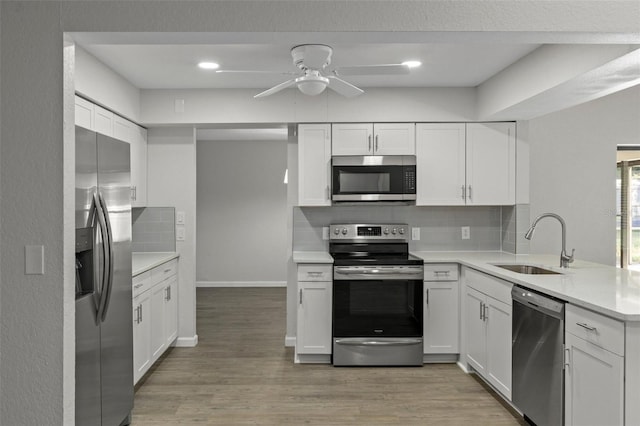 2152 Danforth Rd, Spring Hill, FL 34608 - kitchen featuring stainless steel appliances, a peninsula, light countertops, and backsplash