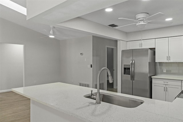 2152 Danforth Rd, Spring Hill, FL 34608 - kitchen featuring stainless steel refrigerator with ice dispenser, ceiling fan, light stone counters, white cabinetry, and recessed lighting