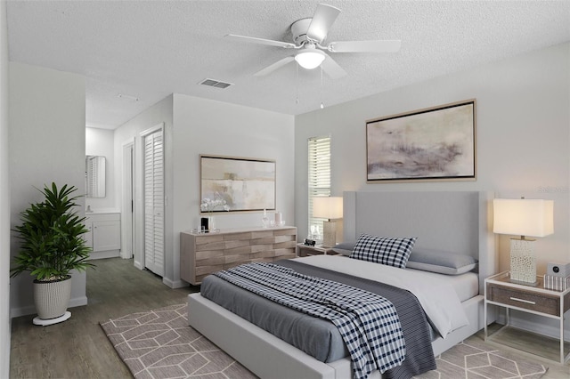 2152 Danforth Rd, Spring Hill, FL 34608 - bedroom featuring wood finished floors, a textured ceiling, and a ceiling fan