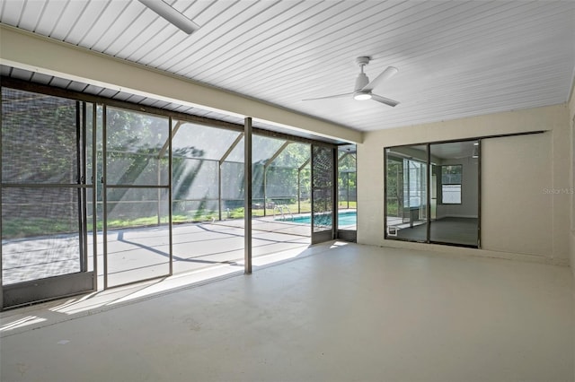 2152 Danforth Rd, Spring Hill, FL 34608 - unfurnished room with concrete floors, a sunroom, and a ceiling fan