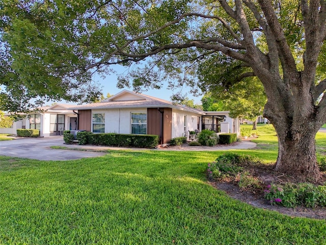 8130 Bugle Ct Unit 3, Port Richey, FL 34668 - ranch-style home featuring a front yard and stucco siding