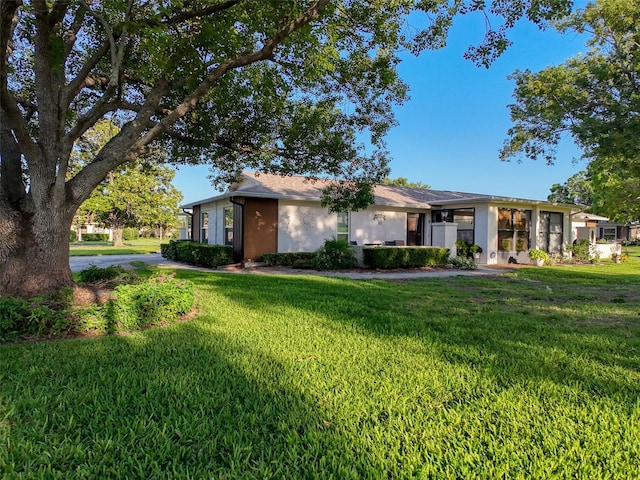 8130 Bugle Ct Unit 3, Port Richey, FL 34668 - view of front of property with a front lawn and stucco siding