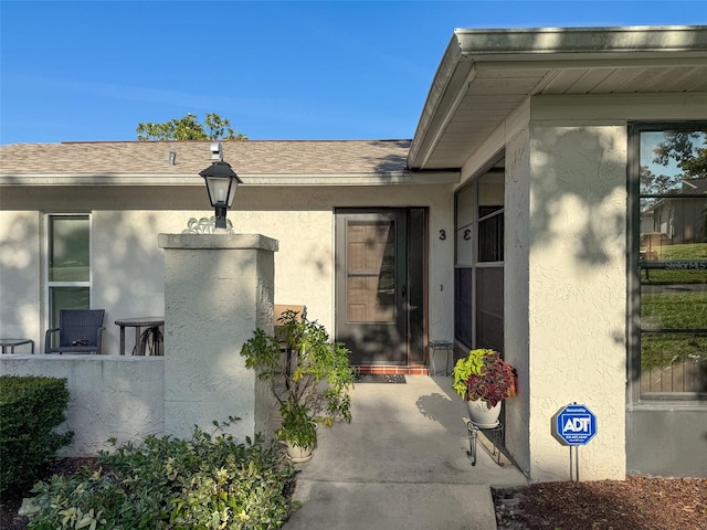 8130 Bugle Ct Unit 3, Port Richey, FL 34668 - property entrance with stucco siding and a shingled roof