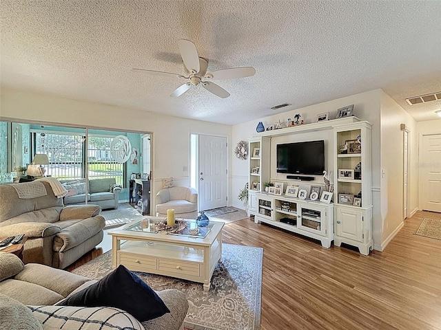 8130 Bugle Ct Unit 3, Port Richey, FL 34668 - living area featuring ceiling fan, wood finished floors, and a textured ceiling