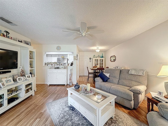 8130 Bugle Ct Unit 3, Port Richey, FL 34668 - living room with a ceiling fan, wood finished floors, and a textured ceiling