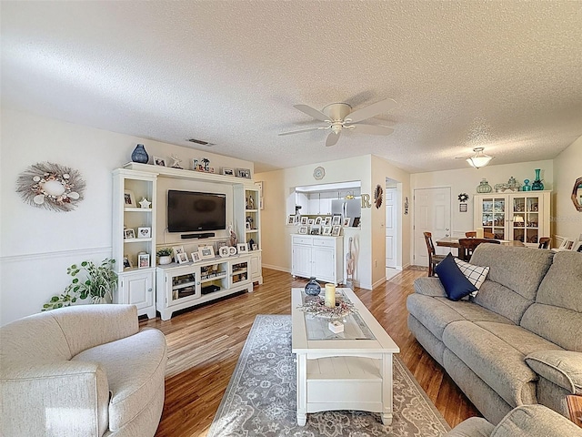 8130 Bugle Ct Unit 3, Port Richey, FL 34668 - living room with ceiling fan, wood finished floors, and a textured ceiling