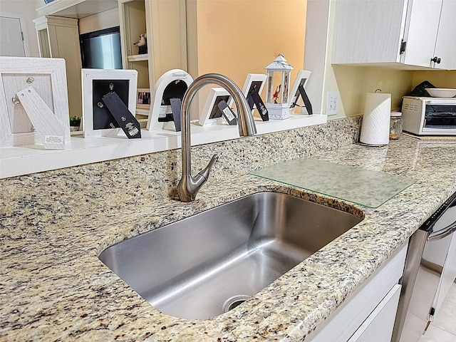 8130 Bugle Ct Unit 3, Port Richey, FL 34668 - kitchen view of light stone countertops and white cabinetry