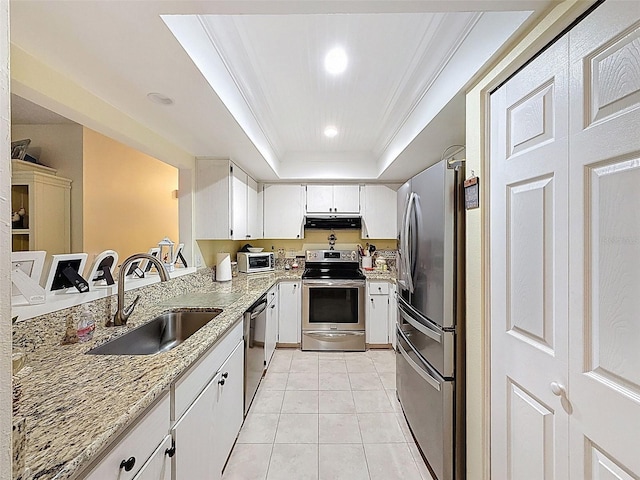 8130 Bugle Ct Unit 3, Port Richey, FL 34668 - kitchen with stainless steel appliances, exhaust hood, light stone countertops, a raised ceiling, and white cabinets