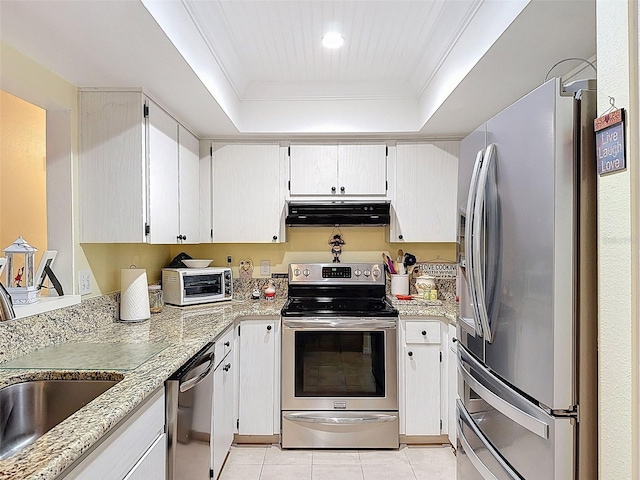 8130 Bugle Ct Unit 3, Port Richey, FL 34668 - kitchen with stainless steel appliances, range hood, a tray ceiling, light tile patterned flooring, and light stone countertops