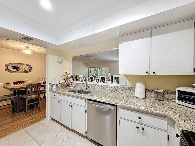 8130 Bugle Ct Unit 3, Port Richey, FL 34668 - kitchen with stainless steel dishwasher, light tile patterned flooring, range, white cabinets, and light stone counters