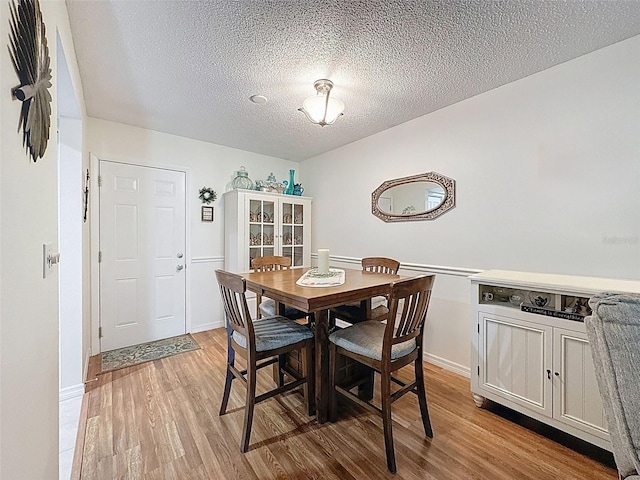 8130 Bugle Ct Unit 3, Port Richey, FL 34668 - dining space featuring wood finished floors and a textured ceiling