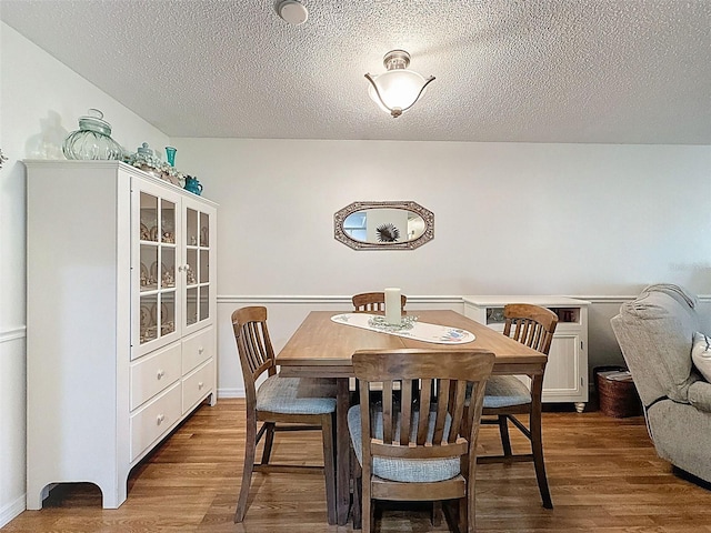 8130 Bugle Ct Unit 3, Port Richey, FL 34668 - dining room featuring wood finished floors and a textured ceiling