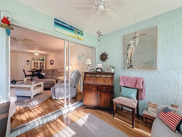 8130 Bugle Ct Unit 3, Port Richey, FL 34668 - living room with a textured wall, ceiling fan, a textured ceiling, and wood finished floors