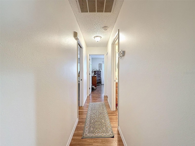 8130 Bugle Ct Unit 3, Port Richey, FL 34668 - hallway featuring wood finished floors and a textured ceiling
