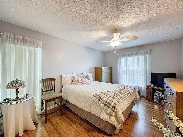 8130 Bugle Ct Unit 3, Port Richey, FL 34668 - bedroom with wood finished floors, ceiling fan, and a textured ceiling