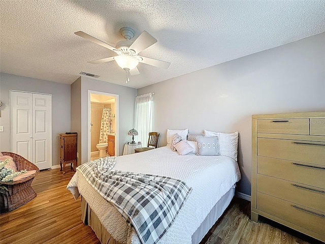 8130 Bugle Ct Unit 3, Port Richey, FL 34668 - bedroom with wood finished floors, a closet, a textured ceiling, a ceiling fan, and ensuite bath