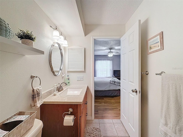 8130 Bugle Ct Unit 3, Port Richey, FL 34668 - bathroom featuring a textured ceiling, tile patterned floors, vanity, ensuite bathroom, and a ceiling fan