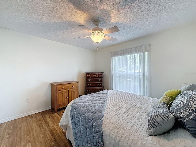 8130 Bugle Ct Unit 3, Port Richey, FL 34668 - bedroom featuring wood finished floors, a ceiling fan, and a textured ceiling