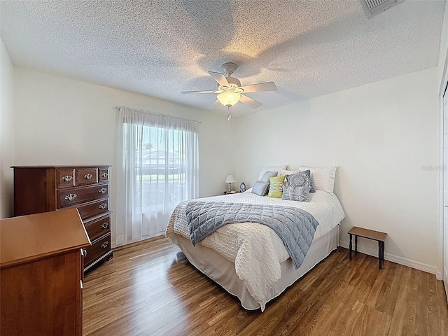 8130 Bugle Ct Unit 3, Port Richey, FL 34668 - bedroom with wood finished floors, a textured ceiling, and ceiling fan