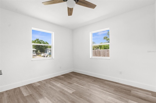 7192 Catalina St, Spring Hill, FL 34606 - unfurnished room with plenty of natural light, wood finished floors, and a ceiling fan