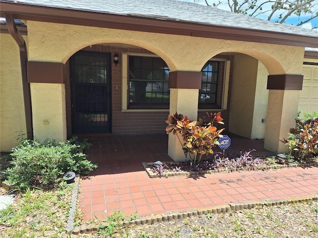 4420 Sawgrass Blvd, New Port Richey, FL 34653 - entrance to property with a shingled roof, covered porch, and stucco siding