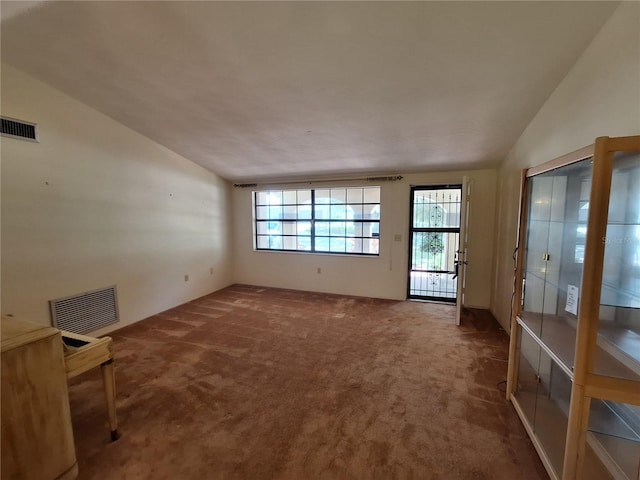 4420 Sawgrass Blvd, New Port Richey, FL 34653 - unfurnished living room with carpet flooring and vaulted ceiling