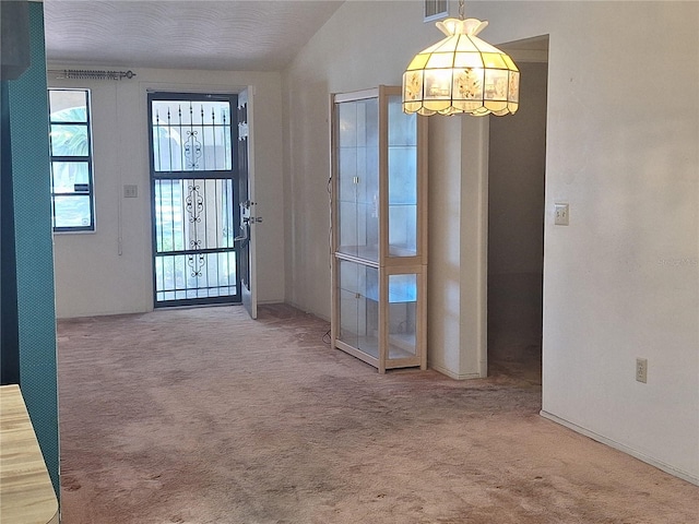 4420 Sawgrass Blvd, New Port Richey, FL 34653 - carpeted entrance foyer with a chandelier, vaulted ceiling, and french doors